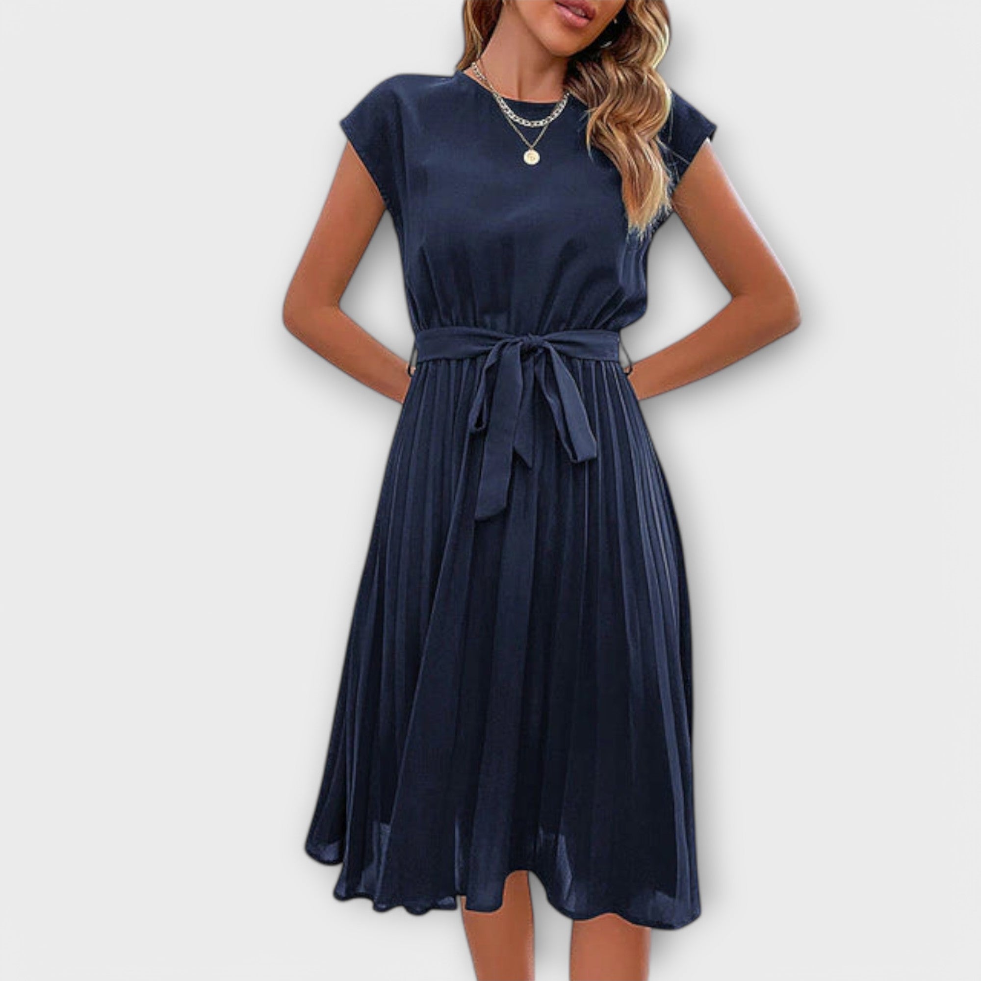 Side view of the Shira Summer Midi Pleated Dress showcasing its flowy style.