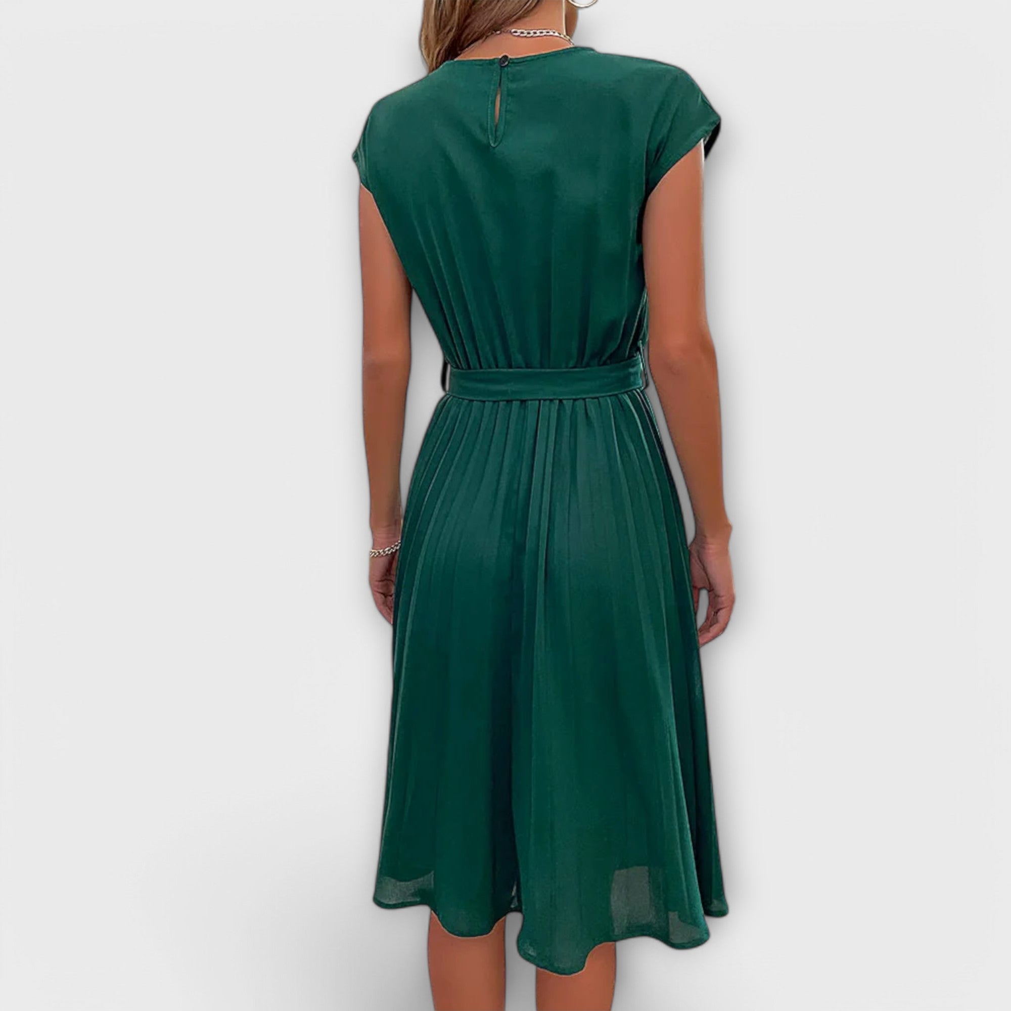 Front view of the Shira Summer Midi Pleated Dress in a natural setting.