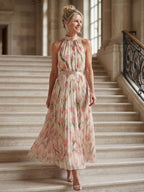 Close up of Aurelia's floral halter neck midi dress